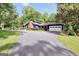 Charming home featuring a brick chimney, large windows, well-manicured lawn, driveway, and two-car garage at 200 Camp Creek Trail, Peachtree City, GA 30269
