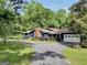 Charming home featuring a brick chimney, large windows, well-manicured lawn, driveway, and two-car garage at 200 Camp Creek Trail, Peachtree City, GA 30269