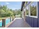 Spacious wooden deck with access to the pool, offering a seamless indoor-outdoor living experience and serene views at 200 Camp Creek Trail, Peachtree City, GA 30269