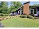 A charming home featuring a brick chimney, large windows, well-manicured lawn, and an inviting walkway at 200 Camp Creek Trail, Peachtree City, GA 30269