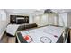 Finished basement featuring a large air hockey table, a flatscreen tv, and built in shelving at 200 Camp Creek Trail, Peachtree City, GA 30269