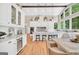 Open kitchen featuring a large island, breakfast bar, custom cabinets, modern appliances, and dining area with backyard views at 200 Camp Creek Trail, Peachtree City, GA 30269