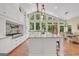 Bright eat-in kitchen with hardwood floors, a large island, modern appliances, and beautiful windows with backyard views at 200 Camp Creek Trail, Peachtree City, GA 30269