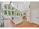 Bright eat-in kitchen with hardwood floors, large island, stainless appliances, and beautiful windows with backyard views at 200 Camp Creek Trail, Peachtree City, GA 30269