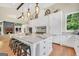Spacious kitchen features a granite island, breakfast bar, and modern stainless appliances with access to the living room at 200 Camp Creek Trail, Peachtree City, GA 30269