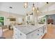 Open-concept kitchen and dining area with granite island, stainless appliances, and lots of natural light at 200 Camp Creek Trail, Peachtree City, GA 30269