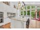 Spacious kitchen with large island, stainless steel appliances, and breakfast bar with high ceilings at 200 Camp Creek Trail, Peachtree City, GA 30269