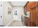 Well-equipped laundry room with ample counter space, cabinets, washer, and dryer at 200 Camp Creek Trail, Peachtree City, GA 30269