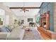 Bright, airy living room with hardwood floors, fireplace, piano, and open to the dining area at 200 Camp Creek Trail, Peachtree City, GA 30269