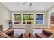 Bright living room features hardwood floors, a cozy fireplace, and large windows with lush backyard views at 200 Camp Creek Trail, Peachtree City, GA 30269