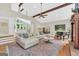 Bright, airy living room with hardwood floors, fireplace, piano, and open to the kitchen and dining areas at 200 Camp Creek Trail, Peachtree City, GA 30269