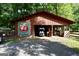 Rustic outbuilding with Phillips 66 sign on a gravel drive, offering ample storage and covered parking space at 200 Camp Creek Trail, Peachtree City, GA 30269