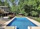Inviting pool area with a diving board and beautiful landscaping around the pool at 200 Camp Creek Trail, Peachtree City, GA 30269