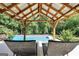Relax in the poolside lounge area featuring comfortable seating and a view of the inviting pool surrounded by lush greenery at 200 Camp Creek Trail, Peachtree City, GA 30269