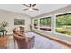 Bright sunroom with large windows offering scenic views and comfortable seating at 200 Camp Creek Trail, Peachtree City, GA 30269
