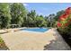 Swimming pool area with diving board surrounded by a concrete patio and lush landscaping, perfect for summer fun at 200 Camp Creek Trail, Peachtree City, GA 30269