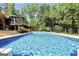 Sparkling swimming pool with clear blue water, perfect for cooling off on hot days, surrounded by lush landscaping at 200 Camp Creek Trail, Peachtree City, GA 30269