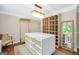 Well-organized walk-in closet featuring custom shelving, drawers, and a central island with a marble countertop at 200 Camp Creek Trail, Peachtree City, GA 30269