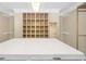 Spacious walk-in closet featuring a central island with marble countertop and custom shelving for optimal organization at 200 Camp Creek Trail, Peachtree City, GA 30269