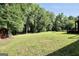 Large green yard with mature trees offering privacy and open space at 200 Camp Creek Trail, Peachtree City, GA 30269