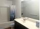 Bathroom featuring single sink vanity, medicine cabinet, and tub with shower at 2282 Joplin St, Jonesboro, GA 30236