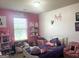 bedroom with pink walls, plush toys and a full bed at 2282 Joplin St, Jonesboro, GA 30236