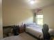 Comfortable carpeted bedroom featuring a lamp and a large window at 2282 Joplin St, Jonesboro, GA 30236