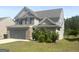 Well-kept two-story home with brick and siding, featuring an attached two-car garage and manicured front yard at 2282 Joplin St, Jonesboro, GA 30236