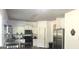 Kitchen with white cabinets, stainless steel appliances and dark wood look floors at 2282 Joplin St, Jonesboro, GA 30236