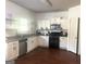 Bright kitchen features granite countertops, white cabinets, stainless steel appliances, and wood-look flooring at 2282 Joplin St, Jonesboro, GA 30236