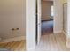 Bathroom entrance showcasing wood floors, neutral walls, and an open door revealing a bedroom beyond at 3402 Milan Ct # 1 Plapprox Sqft 2, Douglasville, GA 30135
