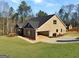 A brick home features an attached garage and driveway, set against a backdrop of lush greenery and blue sky at 3402 Milan Ct # 1 Plapprox Sqft 2, Douglasville, GA 30135