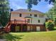Expansive backyard with a wooden deck, a partial brick facade, and ample green space at 308 Bell Isle, Mcdonough, GA 30252