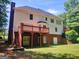 Spacious backyard featuring a wooden deck, stairs, and basement access doors at 308 Bell Isle, Mcdonough, GA 30252