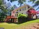 Serene backyard featuring a spacious deck, lovely green spaces and natural landscaping at 308 Bell Isle, Mcdonough, GA 30252