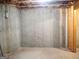 Bare concrete wall in the unfinished basement offers potential for customization at 308 Bell Isle, Mcdonough, GA 30252