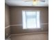 Bedroom featuring neutral paint, carpeted floors and a bright window at 308 Bell Isle, Mcdonough, GA 30252