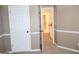 Bedroom with white trim and neutral paint, showing entry to hallway at 308 Bell Isle, Mcdonough, GA 30252