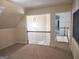 Bright bonus room space illuminated by modern light fixture and neutral carpet at 308 Bell Isle, Mcdonough, GA 30252