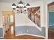 Traditional dining room features hardwood floors, staircase, and decorative chandelier at 308 Bell Isle, Mcdonough, GA 30252