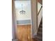 The dining room features hardwood floors, wainscotting, and an elegant chandelier at 308 Bell Isle, Mcdonough, GA 30252