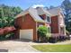 Beautiful brick home with a two-car garage, mature trees, and manicured landscaping at 308 Bell Isle, Mcdonough, GA 30252