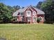 Charming brick home with a well-manicured lawn and beautiful landscaping at 308 Bell Isle, Mcdonough, GA 30252