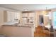 Bright kitchen boasts white cabinets, stainless steel appliances, and granite countertops at 308 Bell Isle, Mcdonough, GA 30252