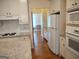 Well-appointed kitchen with granite counters, white cabinets, and stainless steel appliances at 308 Bell Isle, Mcdonough, GA 30252