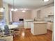Updated eat-in kitchen with hardwood floors, white cabinets, and granite countertops at 308 Bell Isle, Mcdonough, GA 30252