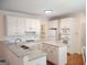 Bright kitchen with white cabinets, granite countertops, and stainless steel appliances at 308 Bell Isle, Mcdonough, GA 30252