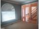 Sunlit living room showcasing a large arched window and an open floor plan at 308 Bell Isle, Mcdonough, GA 30252