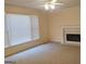 Cozy living room features a ceiling fan, fireplace and large sunny window at 308 Bell Isle, Mcdonough, GA 30252
