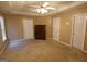 Bedroom featuring a ceiling fan, neutral carpet, and 2 door closet at 235 Woodstream Way, Fayetteville, GA 30214